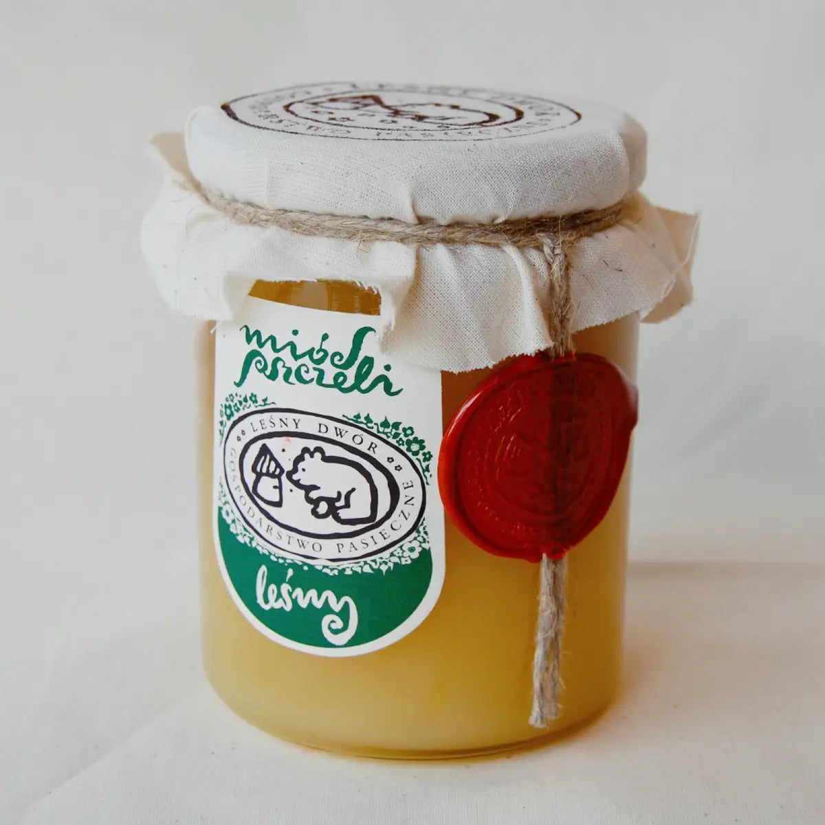 Słoik miodu leśnego.